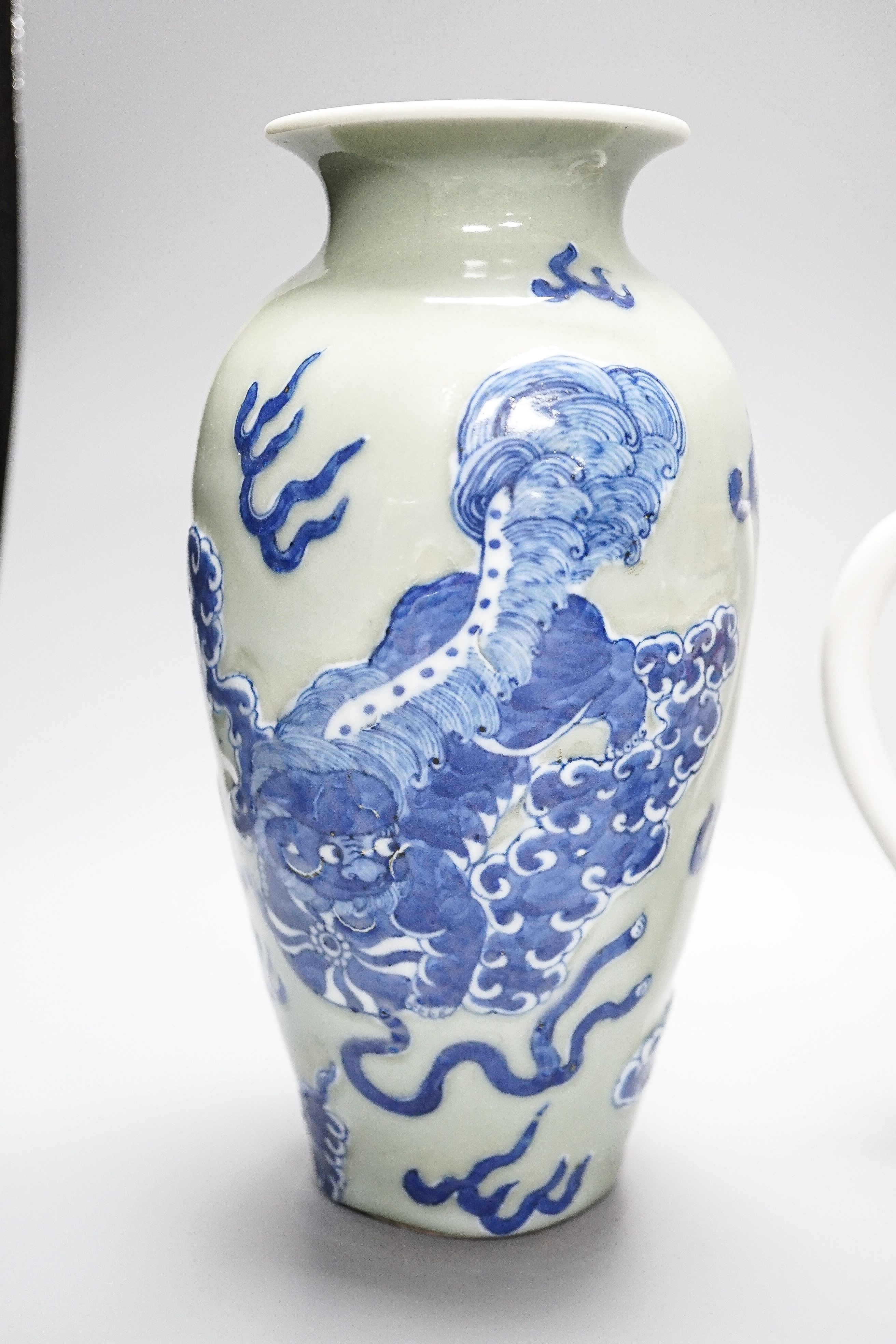 A Chinese celadon glazed vase, 24cm and a Chinese famille rose teapot and matching cream jug, a.f.
